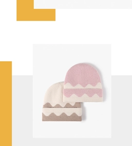 Detail of knitted beanies showing wavy jacquard patterns and ribbed cuff textures