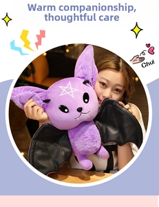 Close-up of purple devil bat plush with black leather wings and white star detail
