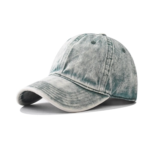 Detail of acid washed denim baseball cap with vintage texture and breathable eyelets