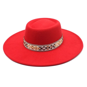 Detail of red wool felt bolero hat with colorful ethnic geometric embroidered band