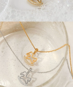 Detailed shot of gold and silver rocking horse necklaces with sparkling cubic zirconia