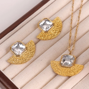 Gold fan-shaped jewelry set with square clear crystals in a beige velvet gift box