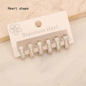 Detailed view of silver stainless steel heart earrings with pave rhinestones set