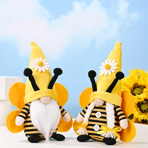 Detail of bee gnomes with plush wings, white braids and daisy accents on sunflowers background