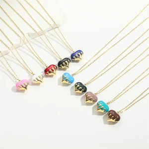 Macro view of heart pendants with colorful drip oil and gold liquid metal finishes