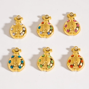Detailed view of six gold ladybug pendants with colorful rhinestones on a white background