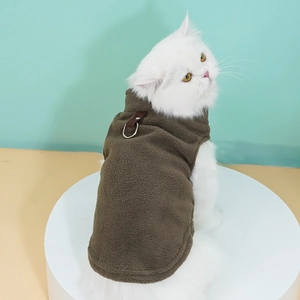 Detail of dog fleece vest featuring reinforced leather strap and metal D-ring for leash