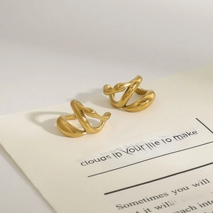 Minimalist gold titanium steel hoop earrings with luxury irregular twisted metal design
