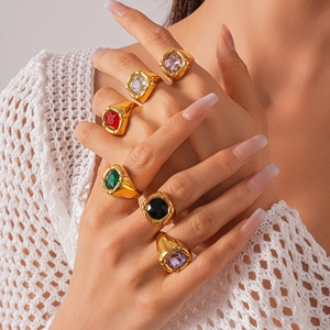 Macro detail of gold vintage rings with geometric colorful square zircon gemstones