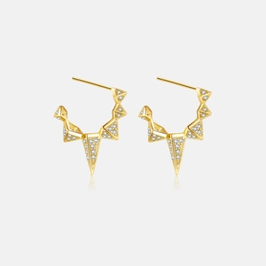 Detailed view of gold-plated geometric triangle earrings with white zircon pavé setting