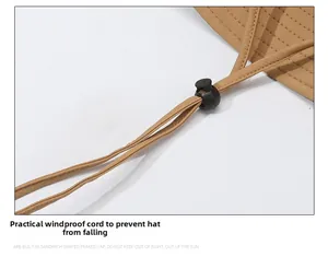 Close-up of adjustable windproof chin strap with toggle on khaki sun hat fabric