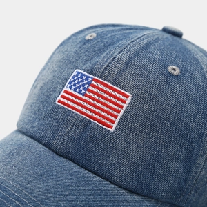 Light blue denim baseball cap with American flag embroidery and vintage washed texture