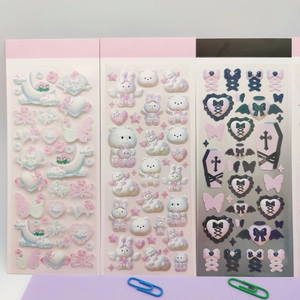 Detailed view of 3D laser anime stickers with butterfly, angel, and gothic patterns