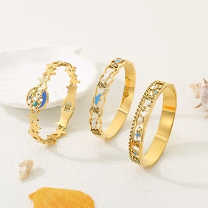 Goldenes Edelstahl-Ozeanarmband mit Seestern-, Delfin- und Meeresbaum-Motiven