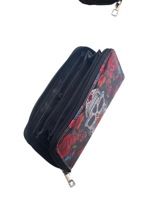 Detail view of long zipper wallet with red roses, skull patterns, and interior card slots