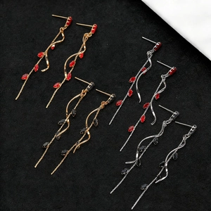 Detailed view of long zircon tassel earrings in four gold and silver color variations