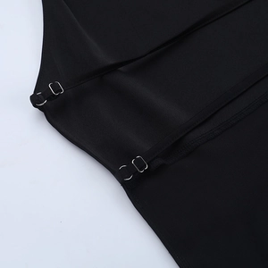 Detailed shot of adjustable shoulder straps with silver metal buckles on a black sleek top