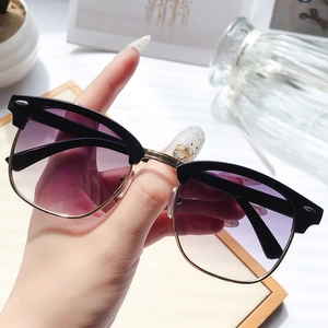 Classic half-frame sunglasses with black top, gold metal trim and purple gradient lenses