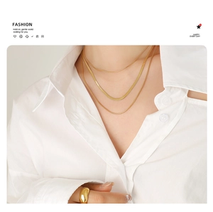 Chic triple-layered gold snake chain necklaces on a model wearing a white shirt