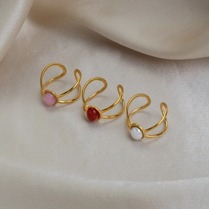 Vintage 18K gold plated stainless steel rings with oval natural stones on silk background