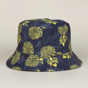 Vue détaillée de l'imprimé ananas tropical sur un chapeau bob bleu réversible.