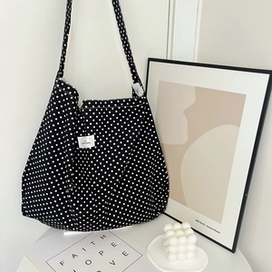 Retro black canvas tote bag with white polka dots featuring large capacity and shoulder strap