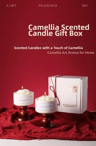 Detailed view of camellia shaped scented candles in ceramic cups with a gift box