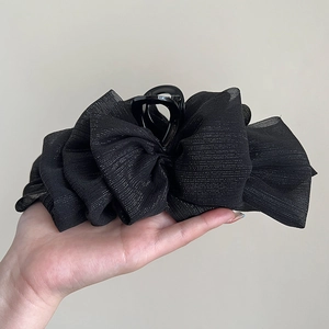 Detailed view of the layered black mesh bow hair claw with shimmering subtle glitter threads