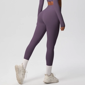 Detail of high-waisted dark purple yoga set featuring sculpting fabric and push-up effect