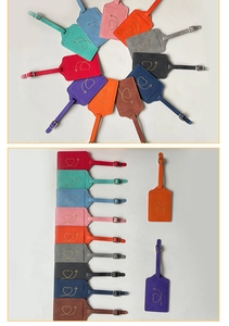 Detailed view of ten colorful PU leather luggage tags with gold heart and plane stamping