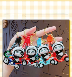 Close-up of four cute cartoon panda motorcycle keychains with matching braided wrist straps