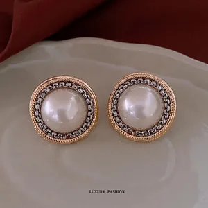 Vintage round pearl stud earrings with silver chain and gold dot textured borders