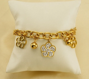 Détail d'un bracelet en acier plaqué or 18k avec breloques fleurs en zircon creux