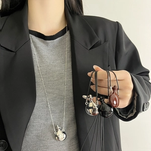 Silver perfume bottle pendant necklace shown in silver, black and reddish brown styles
