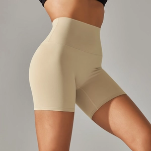 Close-up of beige high-waisted yoga shorts showing seamless cut and soft matte texture