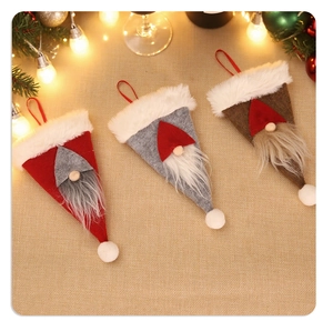 Close-up of felt gnome cutlery holders in red, grey, and brown with festive decor