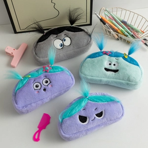 Close-up of fluffy colorful cartoon pencil cases with expressive embroidered faces