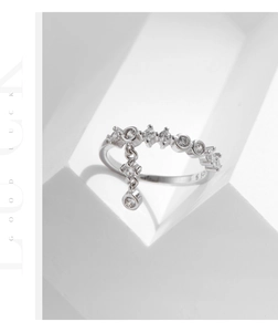 Detail of s925 silver ring with sparkling zircon pavé band and dangling round pendant