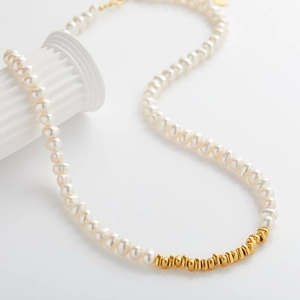Detailed view of s925 silver necklace with white freshwater pearls and gold metal beads