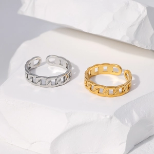 Detail of gold and silver chain style open rings on white artistic display stone