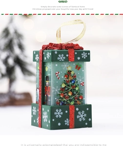 Detail of Christmas gift box ornament featuring nutcracker patterns and gold hanging rope