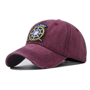 Close-up of distressed brim and Marine embroidery on washed cotton baseball cap