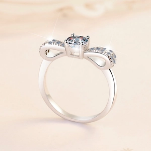 Sparkling S925 sterling silver bow knot ring featuring a brilliant round moissanite stone