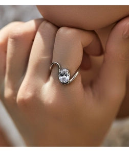 Macro shot of s925 silver ring featuring an oval waterdrop diamond on irregular wavy bands
