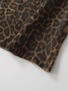 Detail view of leopard print knit texture with ribbed cuffs on a long sleeve top