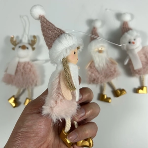 Close-up of handmade plush Christmas tree ornaments in pink and white angel and deer shapes