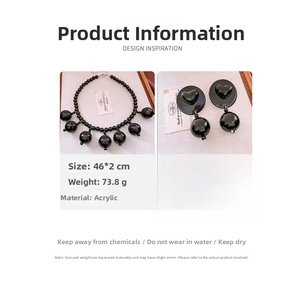 Detail view of black acrylic jewelry set with necklace and earring size specifications