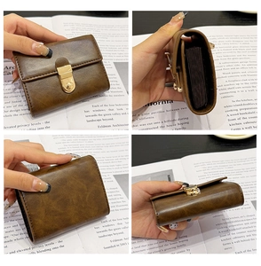 Detail view of deep brown vintage leather card holder with gold clasp and accordion slots