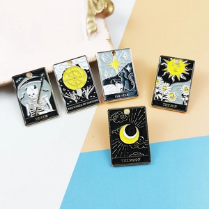 Detailed macro view of five colorful tarot enamel charms including The Sun and The Moon