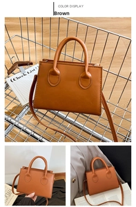 Detailed views of a brown vintage square bag with fine stitching in a shopping cart